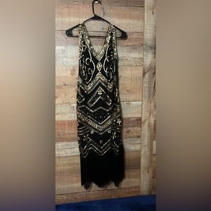 1920s Flipper dress worn once.  Gold & Black.  Well made size Med 8-10 side zip